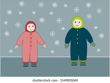 Winter scene: little boy and girl are looking at falling snowflakes