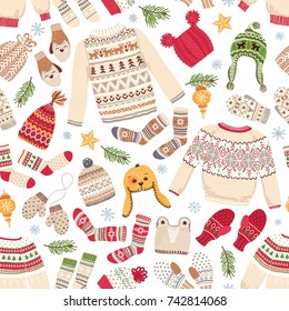 Winter seamless background of knitted warm jumpers, socks, mittens and hats. Vector illustration in Christmas style.