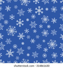 Winter seamless background with white snowflakes on blue background