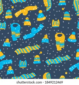 Winter seamless pattern with winter accessories: hats and scarves on blue background. Cute vector winter warm knitted clothes in cartoon style. Christmas vector illustration. Holiday New Year design.