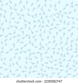 Winter seamless pattern with bird footprints on a bright-blue snowy background