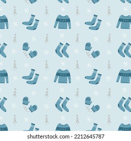 Winter seamless pattern in blue colors - sweaters, socks, trees, ornamented gloves