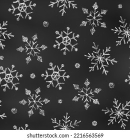 Winter Seamless Pattern of Chalk Drawn Sketches White Snowflakes on Black Chalkboard Backdrop.  Continuous Background of Realistic Crayon-Drawn Snowfall on Blackboard.