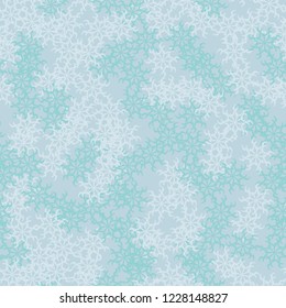 Winter seamless pattern with chaotic snowflakes in different shades of blue color. Light Christmas repeat backdrop using for cards, wallpapers, scrapbooking, print, gift wrap, UFO camouflage etc.