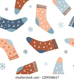 Winter seamless pattern with cute colorful socks and snowflakes. Hand drawn clothing. Flat doodle accessories. Cute cozy colorful background for seasonal textile, paper