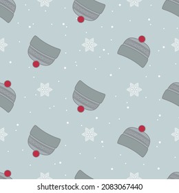 Winter seamless pattern with cute knitted hat and snowflakes. Vector illustration