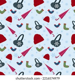 Winter seamless pattern with winter elements. Seamless pattern with winter hat, earmuffs, socks, Umbrella, snowflakes on blue background. vector illustration eps10