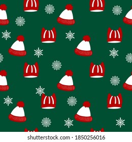 Winter seamless pattern with winter hats on green background. Cute vector winter warm knitted clothes in cartoon style. Christmas vector illustration. Holiday design for fabric, textile, wallpaper.