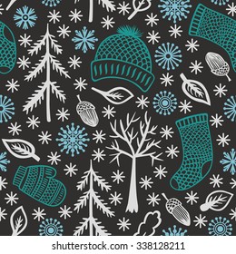 Winter seamless pattern with knitted clothes, snowflakes, trees and acorns. Vector illustration.
