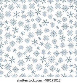 Winter seamless pattern with variety of snowflakes on a white background.