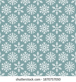 Winter seamless pattern with white snowflakes on blue background. New Year backdrop. Vector flat symmetric Christmas ornament for fabric, textile, wrapping paper, card, invitation, wallpaper