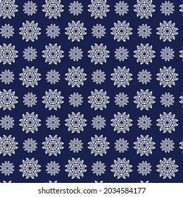 Winter seamless pattern with white snowflakes on blue background. Vector illustration for fabric, textile wallpaper, posters, gift wrapping paper. Christmas vector illustration. 