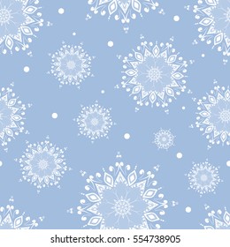 Winter seamless pattern. White snowflakes on blue background, Mandala. Round Ornament Pattern. Geometric circle element made in vector.  Oriental motifs.  