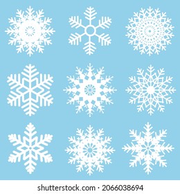 Winter set of white snowflakes isolated on light blue background. Snowflake icons. Snowflakes collection for design Christmas and New Year banner and cards.