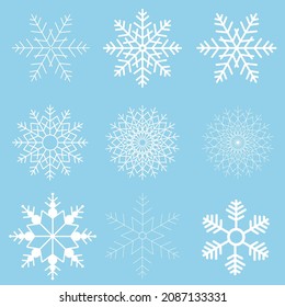 Winter set of white snowflakes isolated on light blue background. Snowflake icons. Snowflakes collection for design Christmas and New Year banner and cards.