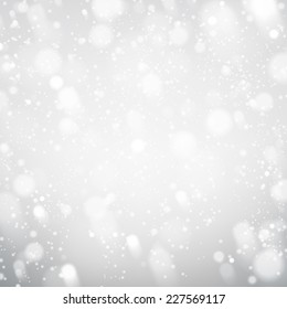 Winter silver background. Fallen defocused snowflakes. Christmas. Vector.   