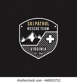 Winter Ski Patrol, Rescue Team Label With Mountains. Vintage Extreme Adventure Badge. Outdoors Logo Design. Travel Hand Drawn And Hipster Insignia. Wilderness Stamp Isolate On Dark. Vector