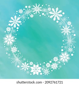 Winter snowflake wreath isolated on an aqua blue background. Illustration of white icy snowflakes in a circular motion pattern. Frosty winter background