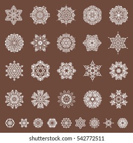 Winter snowflakes icon collection. Christmas snowflakes set with doodles and dots on a brown background. Vector Christmas background.