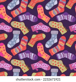 Winter socks seamless pattern on purple background. Doodle socks with different texture and color. For textile, wrapping paper, packaging.