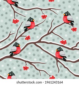 Winter theme seamless pattern with bullfinches, rowan berries and snowflakes. Vector illustration.