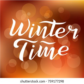 Winter time custom white lettering text on blurred background with lights, vector illustration. Winter time calligraphy for logo, invitation, poster, decoration and postcards. Winter vector design.