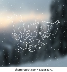 Winter time hand-drawn lettering calligraphy quote on winter blurred background. 
