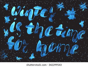 Winter is the time for home-  freehand brush calligraphy with the rough edges. Inspirational words isolated on the abstract confetti background.