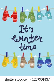 It's winter time. Set of mittens hanging on the rope with lettering. Vector illustration.
