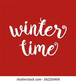 Winter time typographic poster. Vector hand drawn phrase.  Vector ink painted lettering on red wool knitted background. Banner with phrase for poster, tshirt, banner, card and other design projects. 
