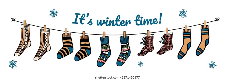 It's winter time. Warm winter socks with different patterns hanging on a rope. Cute woolen or knitted clothes and motivation phrase isolated on white background. Cartoon flat vector illustration