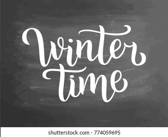 Winter time white lettering text on chalkboard background, vector illustration. White brush calligraphy for logo, invitation, banner, menu and postcards. Letters on blackboard design