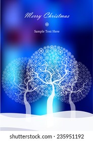 winter trees of snowflakes isolated on blurry blue background