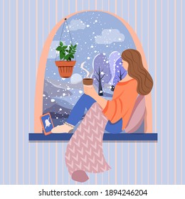 Winter Window, Snowy Weather. Woman Is Sitting On The Windowsill With A Warm Blanket And Holding Coffee In Her Hands.