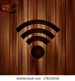 Wireless web icon. Wooden background.
