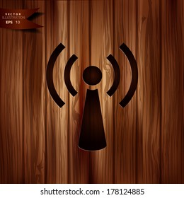 Wireless web icon. Wooden background.
