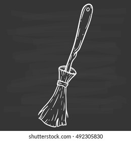 witch broomstick using hand drawing or doodle art on chalkboard background