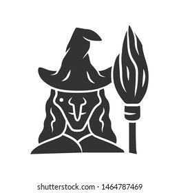 Witch glyph icon. Silhouette symbol. Wicked sorceress, hag with broomstick. Halloween costume. Evil old woman in wizard hat and broom stick. Negative space. Vector isolated illustration