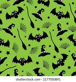 Witch hat, bat, spider web, and broom hand drawn seamless pattern on green color background for Halloween.