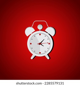 withe clasic alarm clock on a red background in the studio