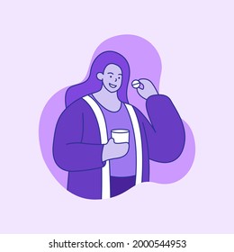 A woman is about to take a pill with a glass of water