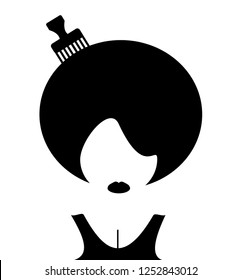 woman with afro and comb in hair