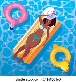 woman afro tanning in float on the pool