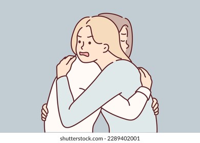 Woman with angry expression hugs girl friend hiding envy or jealousy in order to deceive. Concept hypocrisy and lack of trust between close relatives or old friends due to envy and insincerity 