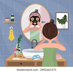 Woman applying facial mask in the bathroom.