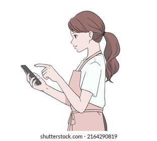 A woman in an apron operating a smartphone