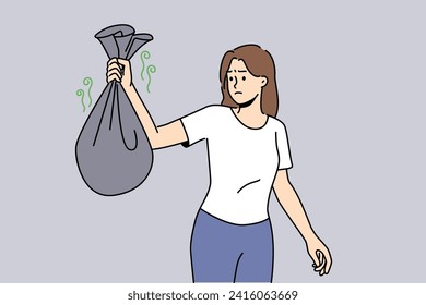 Woman with bag of smelly garbage in hands carries waste into trash can and feels disgusted because of bad smell. Girl throws out organic waste in dark plastic bags, not wanting to sort garbage.