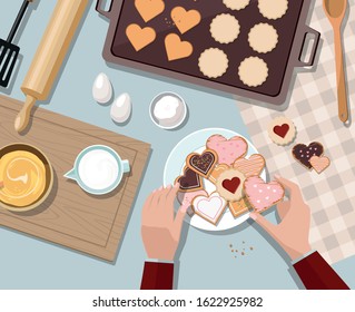 Woman baking. Baking utensils and cooking ingredients for tarts, cookies, dough and pastry. Valentine's day. Top view.