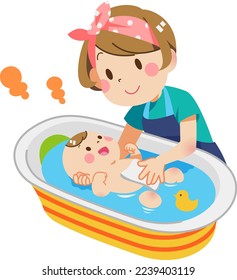 Woman bathing baby in baby bath