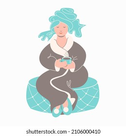 Woman in bathrobe with cup of tea